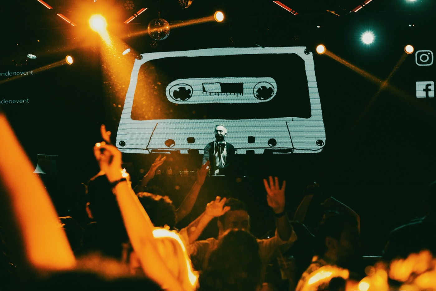 Crowd at a DJ Denden 90s Turkish Pop Night, cassette tape stage visual