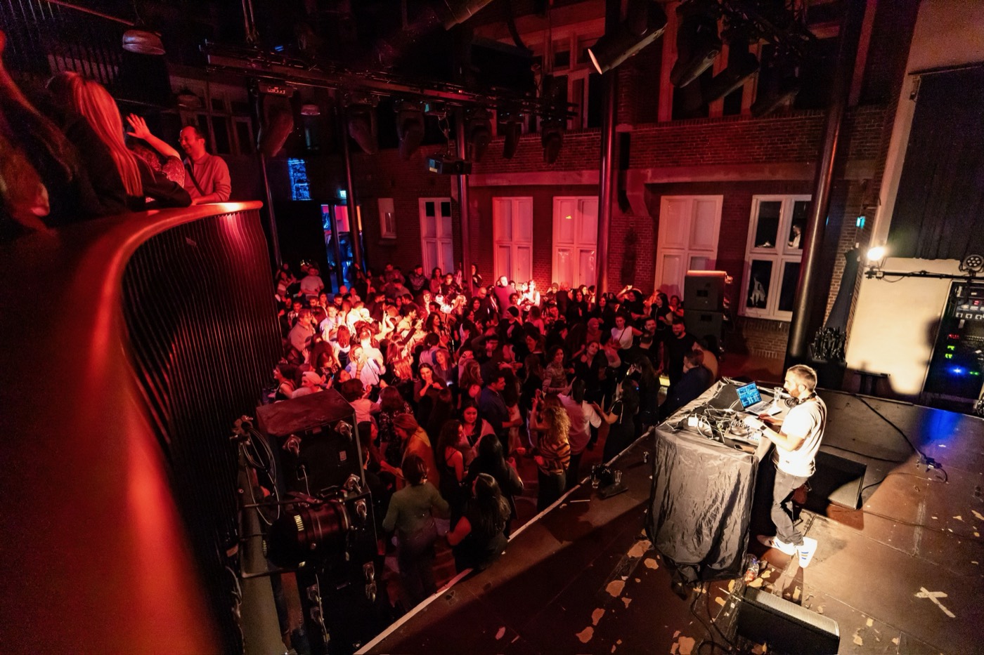 Packed venue seen from the balcony during a DJ Denden set